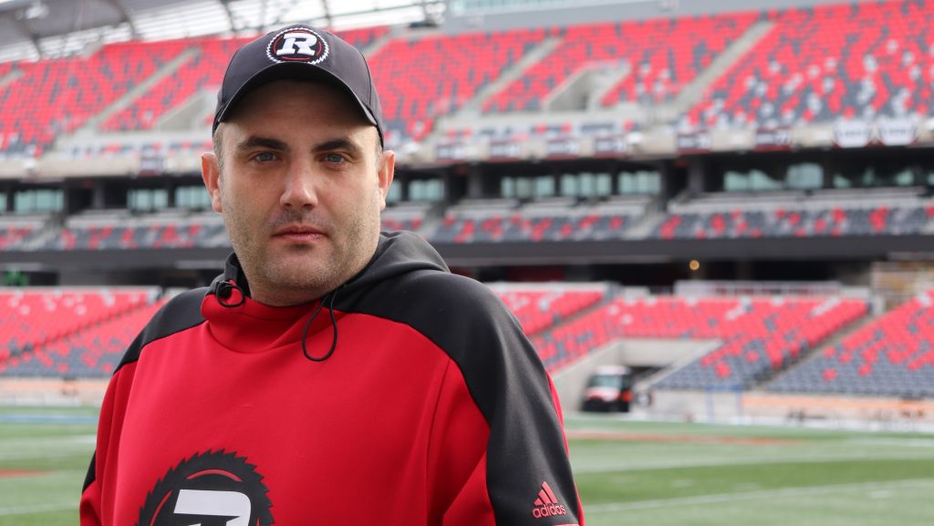 Chris Hofley, communications and content specialist for OSEG, stands on the field of TD Place.