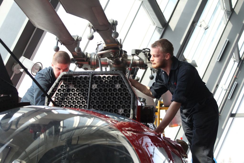 Second-year aircraft maintenance students Zac Rennick and Nicholas Konynenberg doing practical training on a helicopter. It was donated by the Canadian Coast Guard.