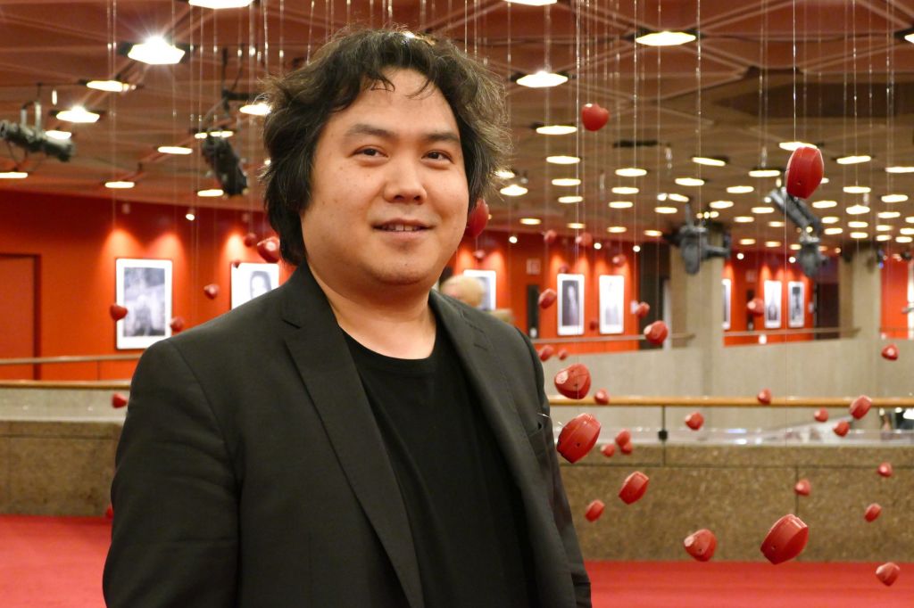 Violinist Yosuke Kawasaki walks through the National Arts Centre before he appears in concert on Feb. 14. He has been the NAC Orchestra's concertmaster for the last 11 years and doesn't intend to change that any time soon.