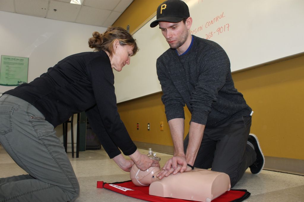 Marianne Black teaches first-aid to her student, Warren Vibert-Adams, on a mannequin. This practice could be necessary in an overdose situation.