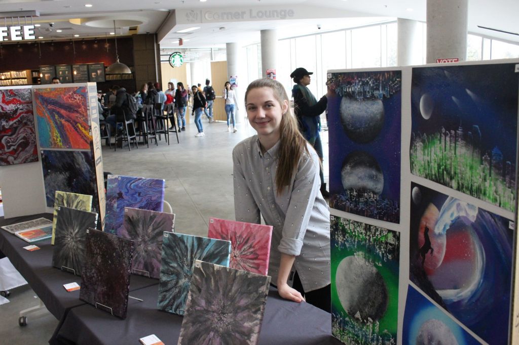 Annalee Kanwisher showing and selling her paintings in the AC Market on March 21. This gives chance for students to showcase their business and products.