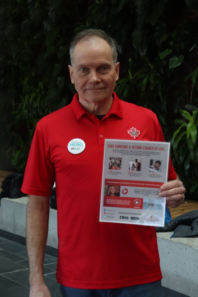 Steve Gleddie poses with a Canadian Blood Services pamphlet. He is one of the volunteers recruiting students at the Student Commons March 27.