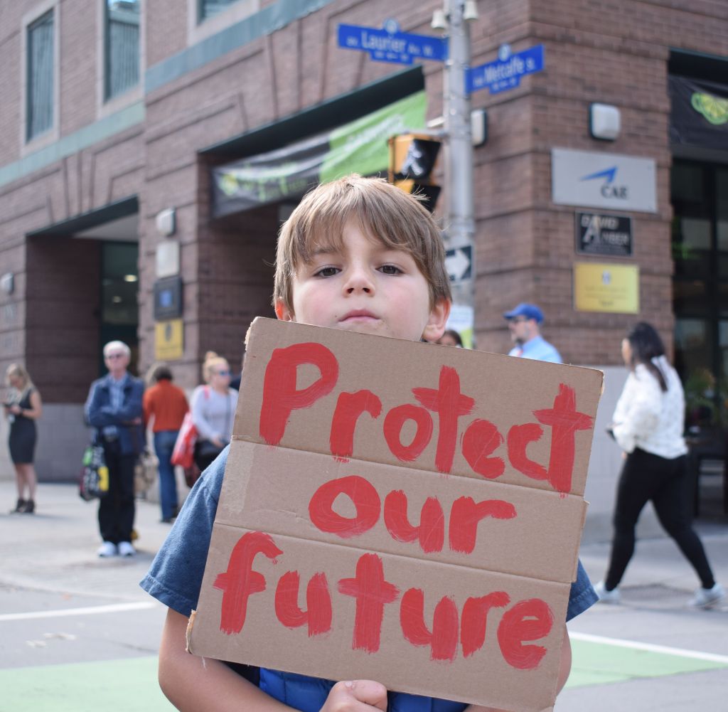 Young man Jackson shows his thoughts this Global Climate Strike day on Friday, Sept. 27.