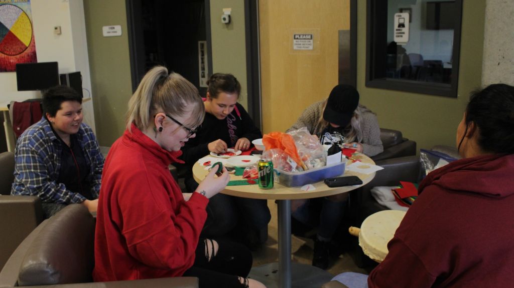 Students at the Mamidosewin Centre doing beaded crafts.