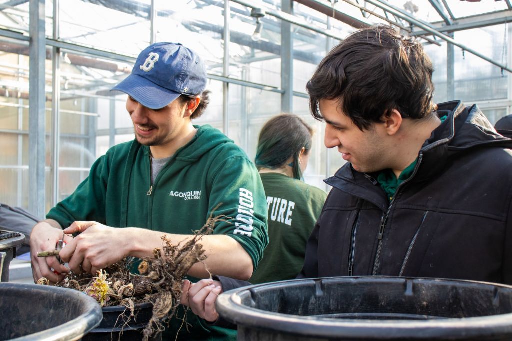 Sam Dalley (left) works with classmate Riley Ransom (right) to winterize plants and equipment for the coming months. Though an outdoor-oriented program, the horticulture program prepares students with many other applicable skills.