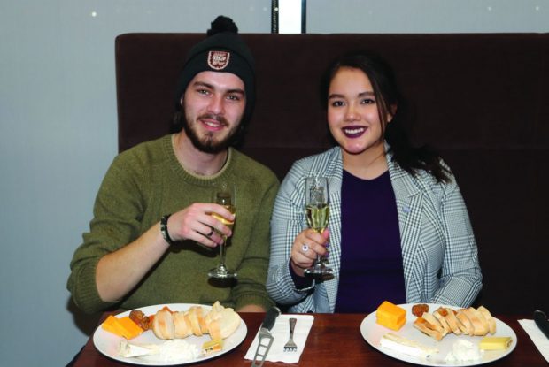 Joshua Hall and Allison MacLeod, aboriginal studies students at Algonquin College, enjoy an evening of wine and cheese pairings together.