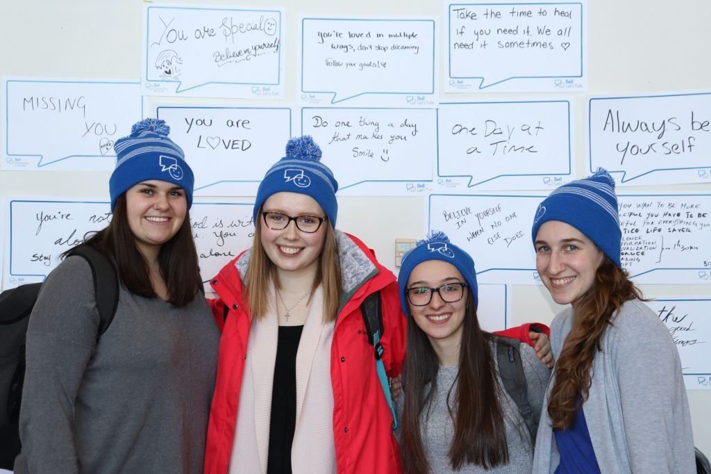 Second-year Early Childhood Education students Hailey Lachance, Abbie Frazer, Alyssa Lapointe and Faith Savoy are sporting Bell Let's Talk hats at the Happy Place Event.