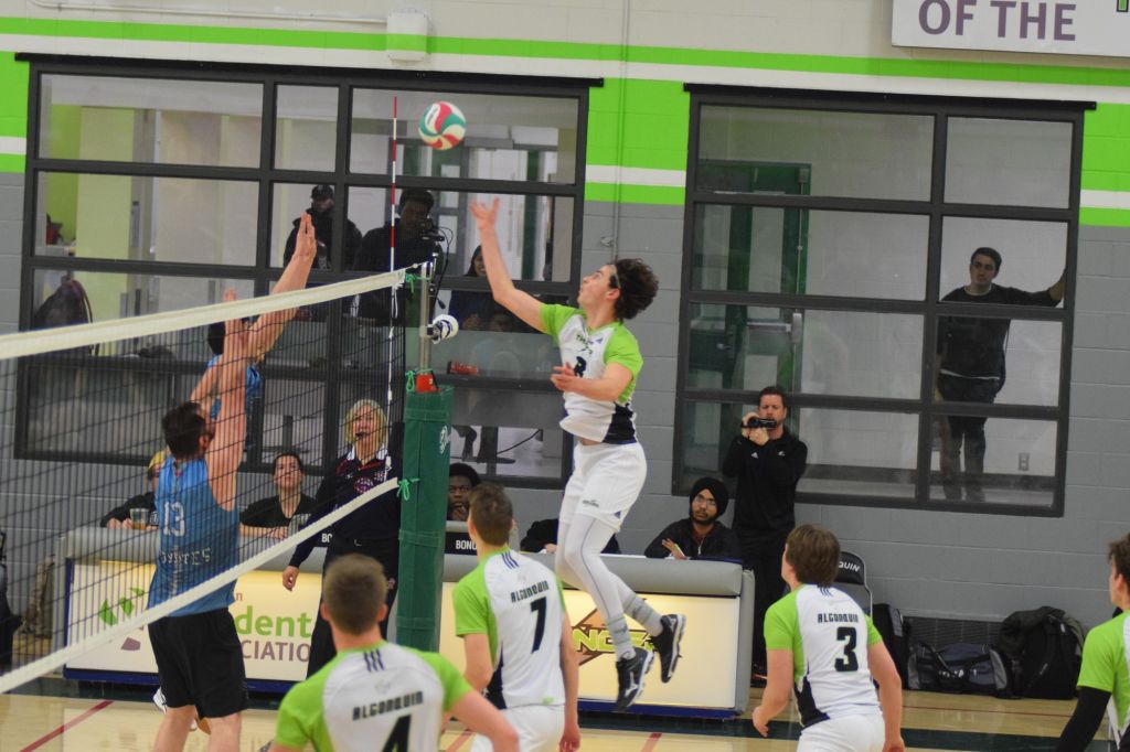 Tom Cullingworth soars to tip the volleyball over the net during Friday night's game versus the La Cite Coyotes.