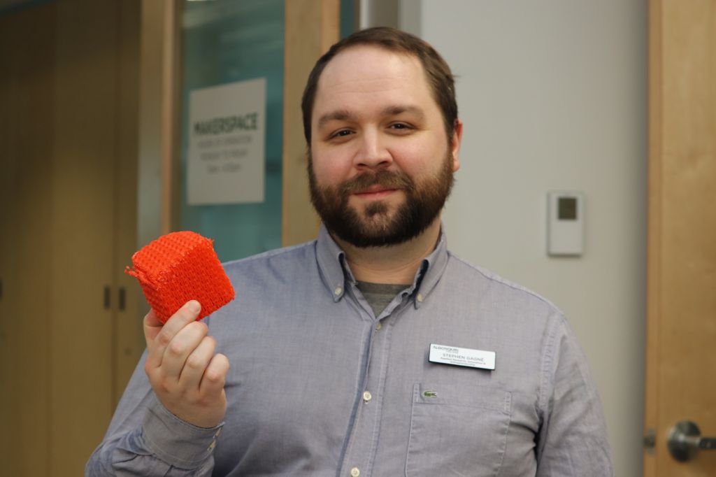 Makerspace acting manager Stephen Gagne shows off a design replica created at the lab.
