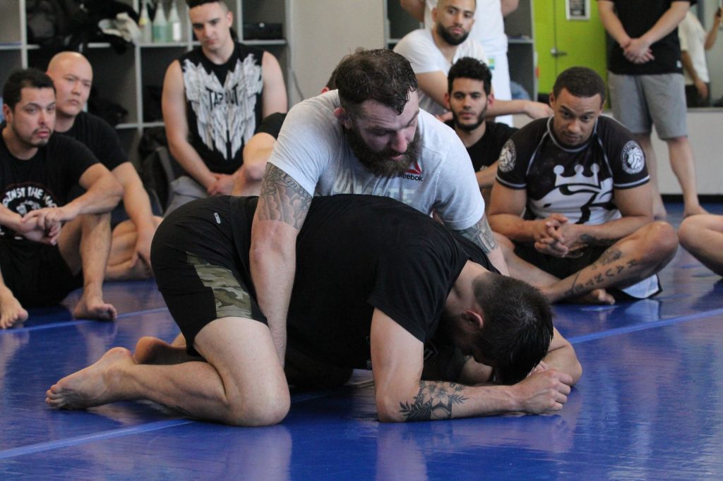 UFC's Michael Chiesa and Carlos Condit demonstrate a Jiu Jitsu technique to attendees.