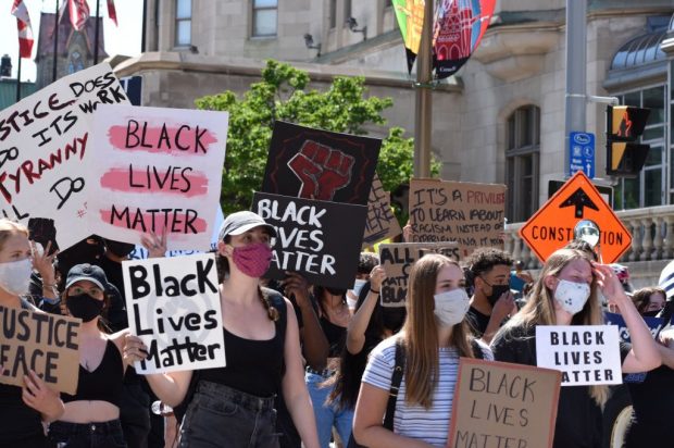 Black lives matter supporters stand in unison