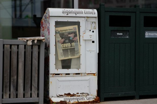 An old newspaper box with the last print edition of the Algonquin Times, published March 13, 2020, just before the the school was shut down