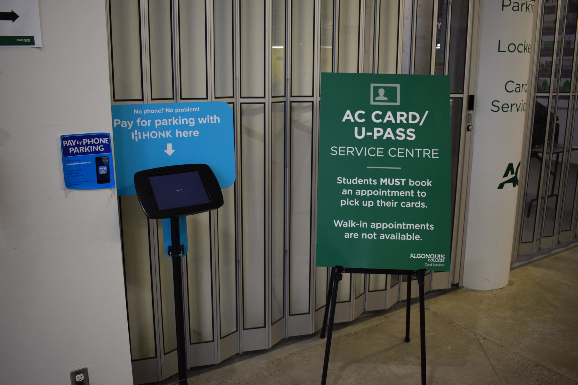 A sign outside the U-Pass service centre explains students must book an appointment in order to pick up their cards