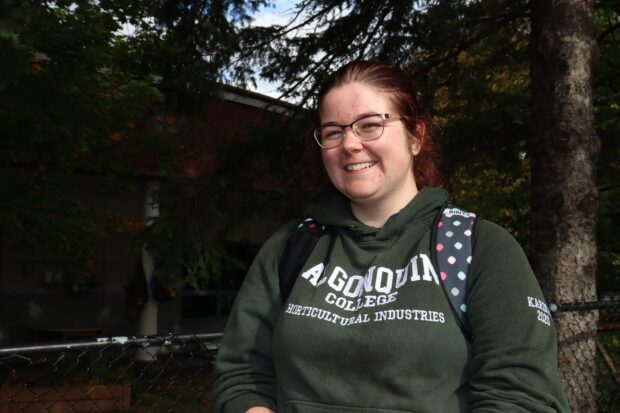 Karina McIsaac, a horticultural industries student walks around campus with flowers in her hand.