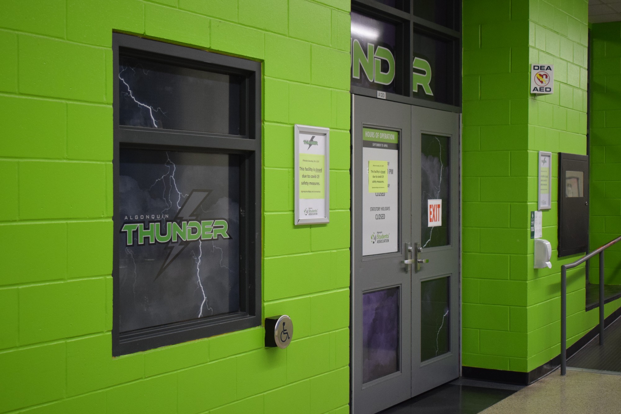 The Ron Port Athletic Facility entrance doors with a sign that says the gymnasium is currently closed.