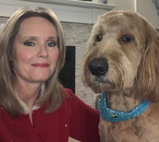 Tracy McDougall and Monte, golden doodle, are working from home and keeping in touch with students trough virtual meetings.