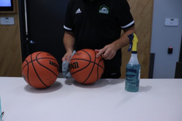 Athletics and recreation centre staff member, Mike Ciolfi sanitizing the basketballs between each use to ensure COVID-19 protocols are being followed.