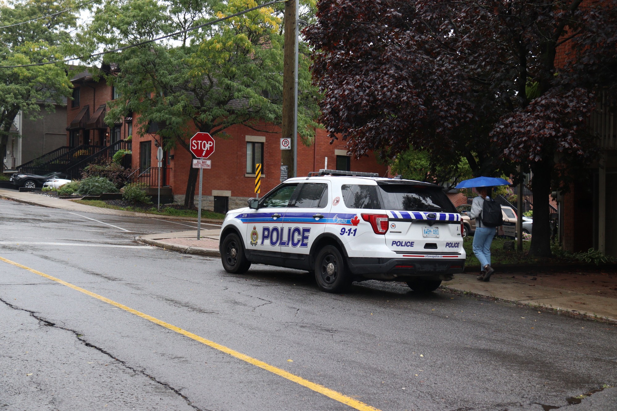 Police presence remains on Russell Avenue on Sunday afternoon the day after the party.