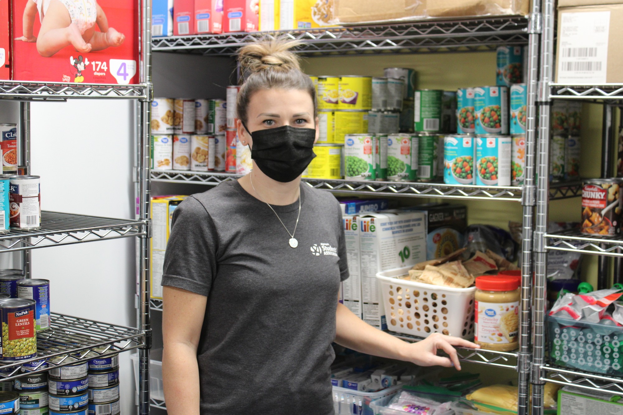 Jessica McCabe, food cupboard coordinator, is shown in the Woodroffe campus of AC.The shelves are full of food and other items for students to access if needed.