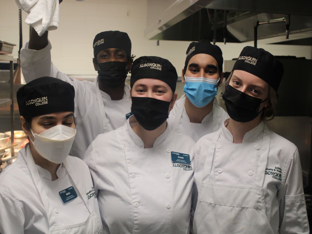 Culinary management students display their pleasure to be back at Restaurant International.