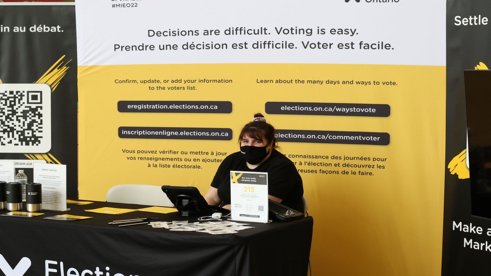 Samantha Ranger, a host, sits at the Student Commons voting booth at Algonquin College.