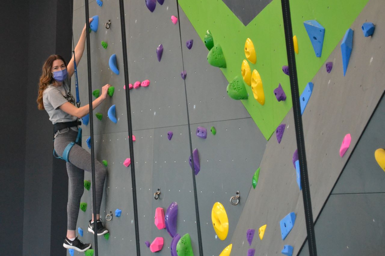 Cassandra Jones St. Onge demonstrates how to use the ARC's newly-opened climbing wall safely and efficiently.