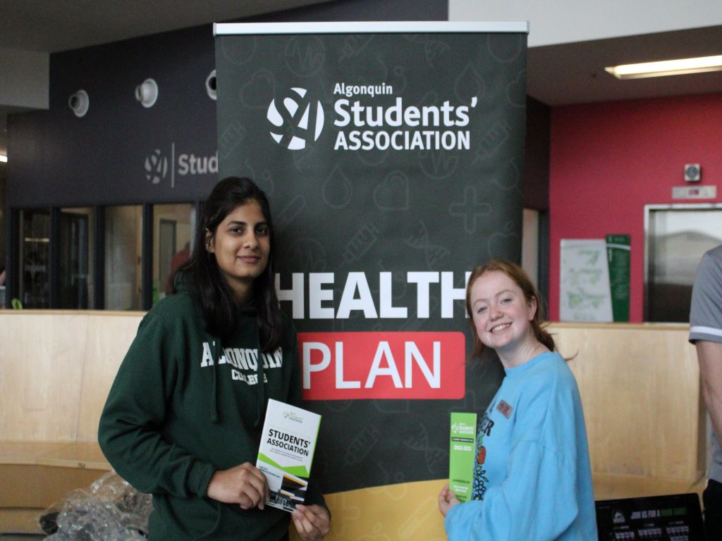 Gwyn Jones and Bhavya Taneja promoting the new and improved health plan at the Campus Village.