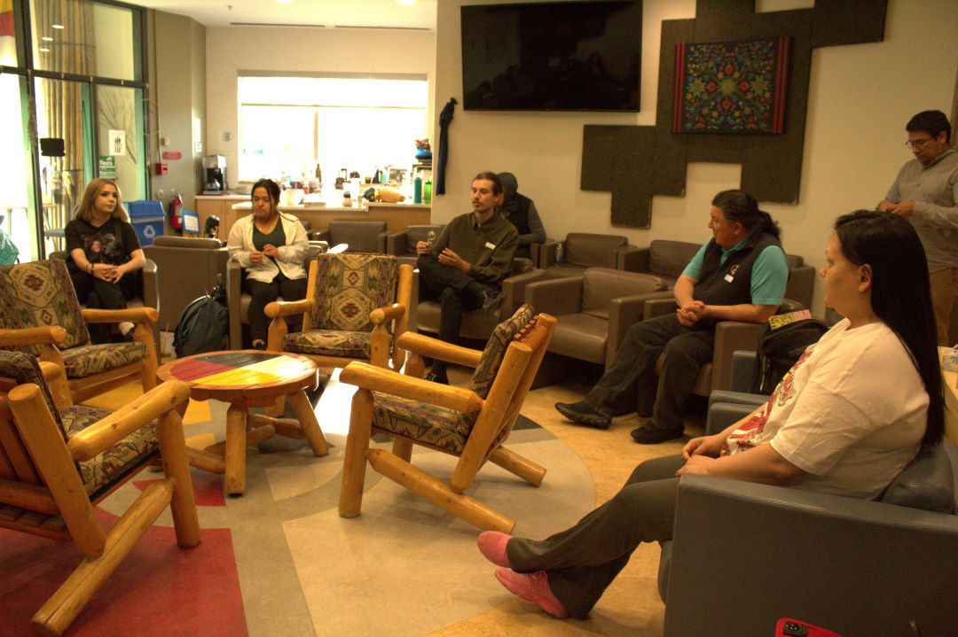 Sitting in a circle, students discuss current Indigenous issues.