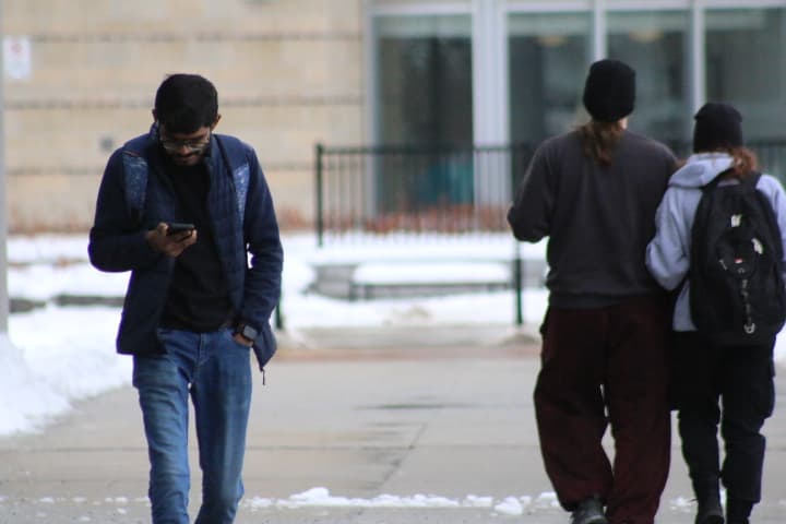 Students walk between Algonquin College buildings on Wednesday. Students last Thursday were checking for updates from the college as a storm approached Ottawa.