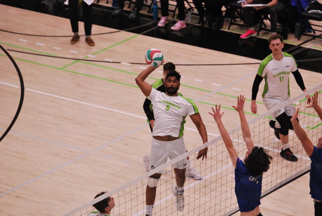Prasanah Jeyapalasingham spikes the ball past two Georgian Grizzlies on the way to a 3-1 win Friday night.