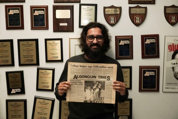 Aadil Naik holds the first printed edition of the Algonquin Times from 1987.