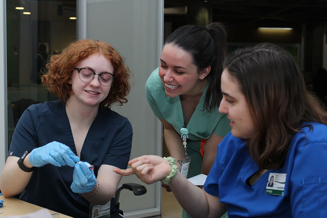 Algonquin College nursing students practice drawing blood for an upcoming exam. From left to right, Olivia Westland, Sam Channon, and Addie Wilson.