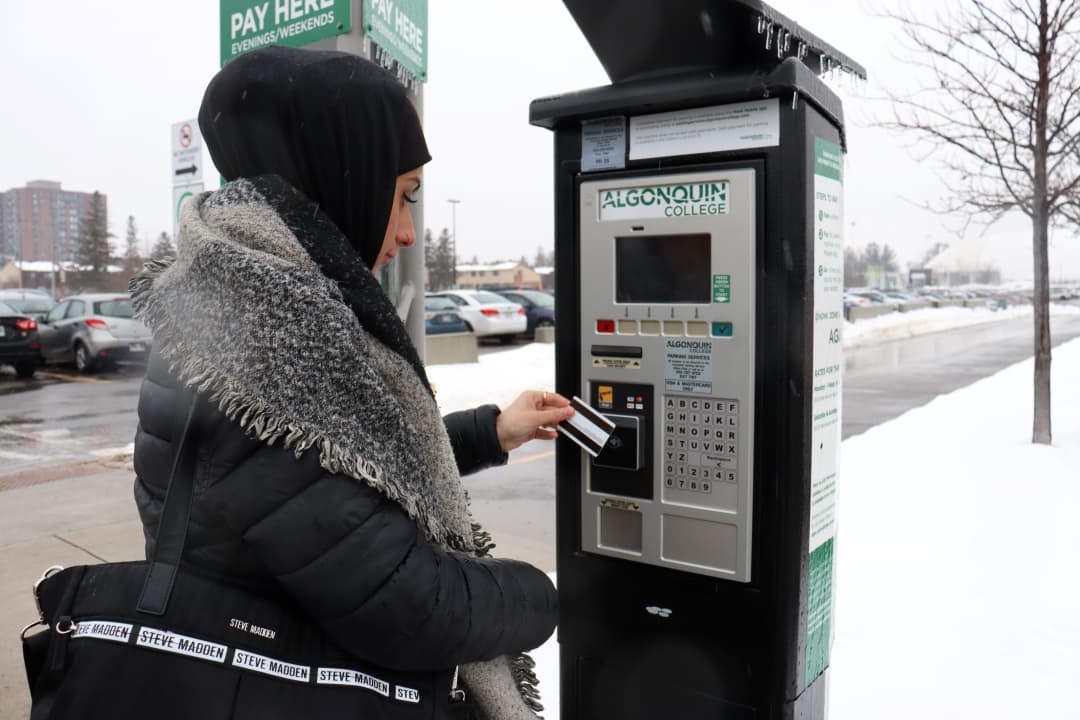 Zahra El Haj Hassan paying for parking on campus.