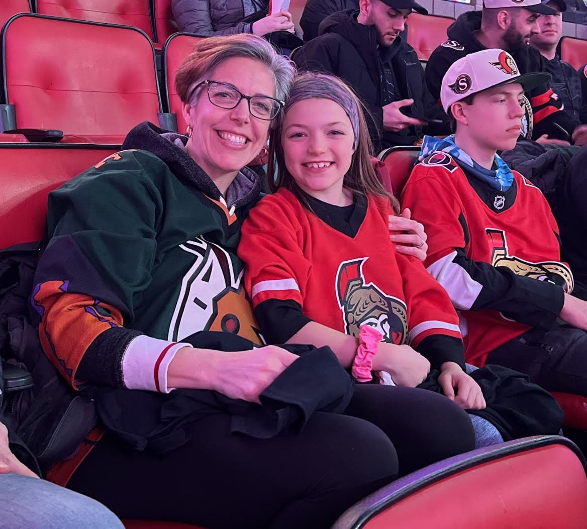 A mother and daughter have a great time while watching their Senators play.