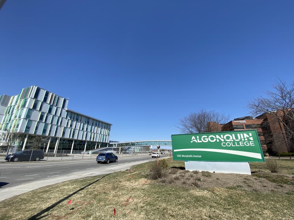 Outside view of the Algonquin College footbridge over Woodroofe Avenue on a sunny April afternoon.