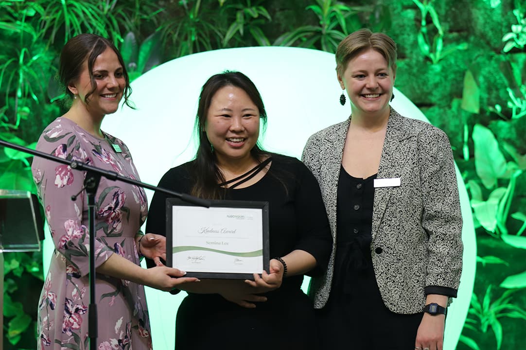 Semina Lee receiving the Kindness Award posing with Elizabeth Holmes and Leah Grimes from Student Support Services. Lee showed up to volunteering events with the biggest smile on her face.