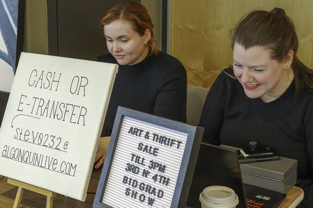 Interior design students Mackenzie Wegman, left, and Haley Stevenson, right, collected money from an art and thrift sale fundraiser for their 2023 grad show.