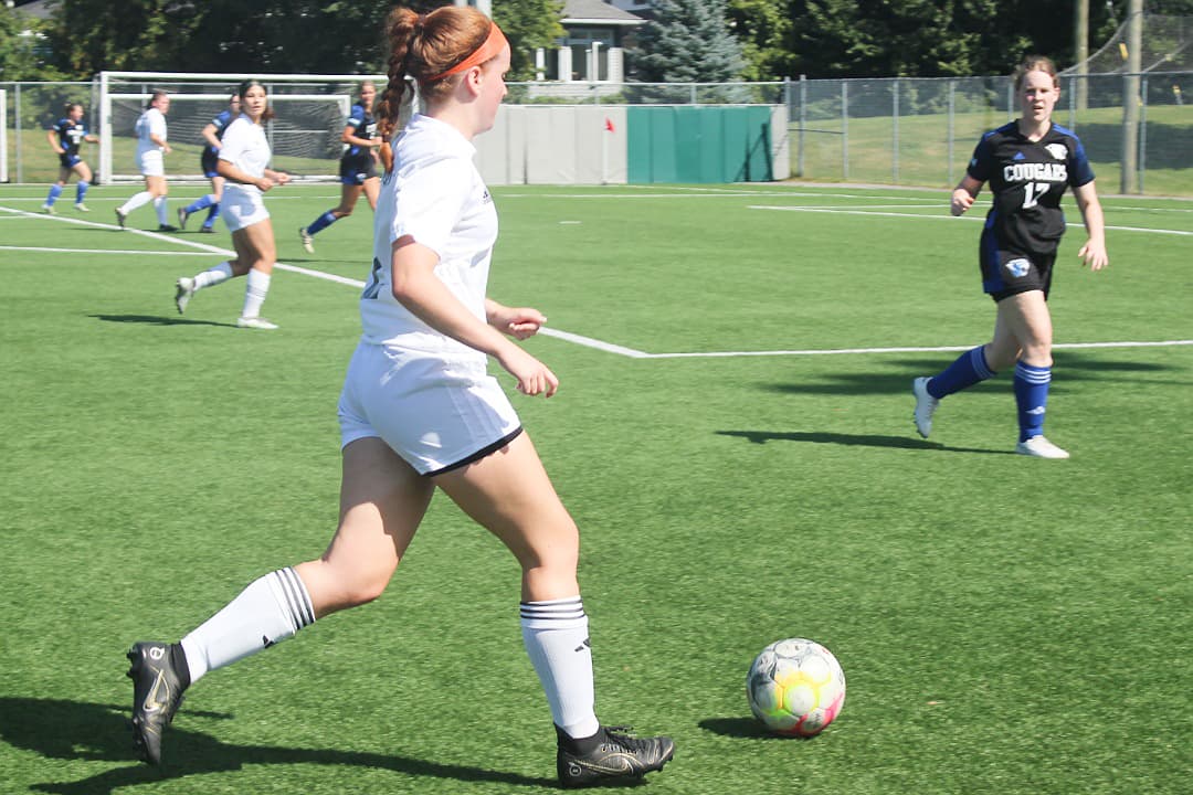 Olivia Lambert gears up to strike the ball into the Cougars' zone on Sept. 9.