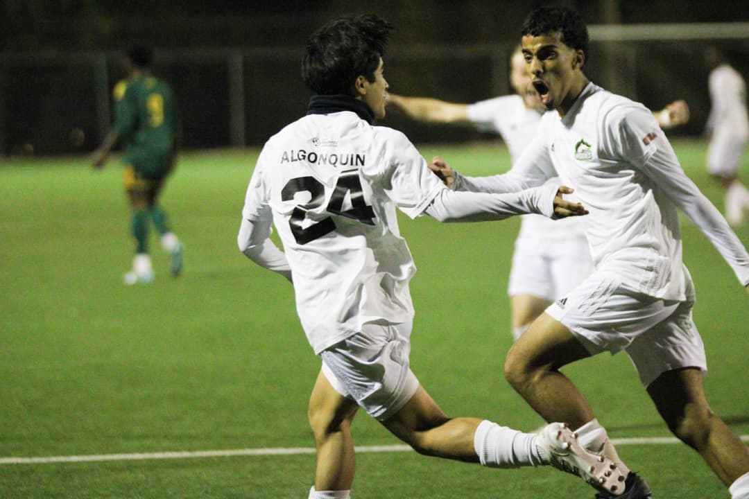 Cristian Aviles-Molina (left) runs to celebrate his first goal of the night with Ali Sultan (right) at Algonquin College sports field on Oct.18