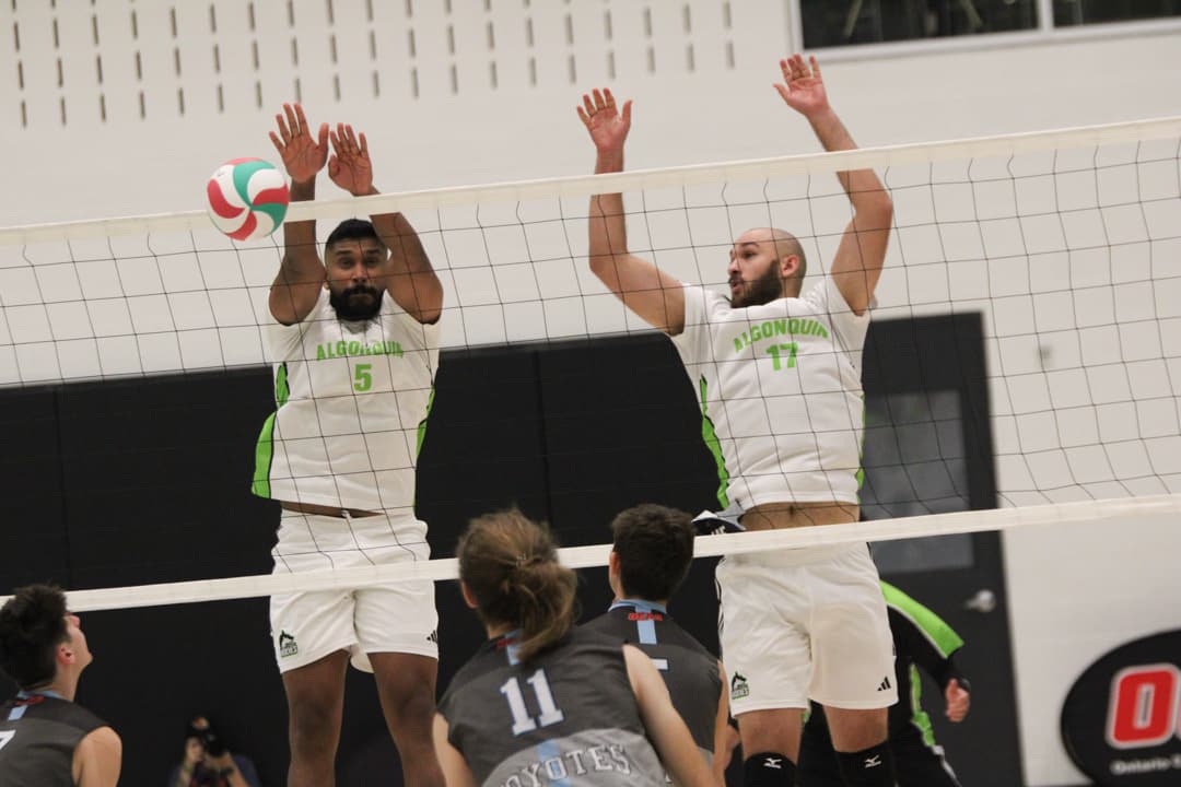 Pras Jeyapalasingham (left) and Mahmoud Abdelaziz (right) jump to block the ball against La Cité at the Jack Doyle Athletics and Recreation Centre on Oct. 20.