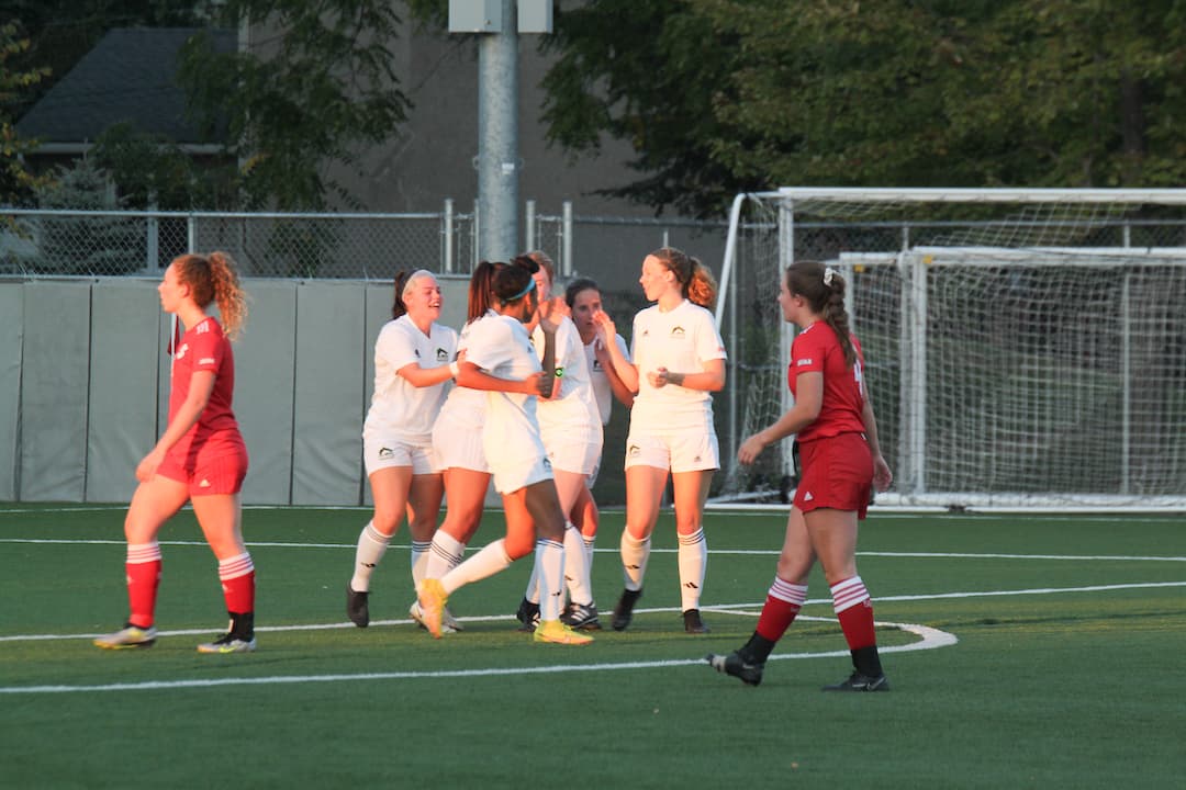 Algonquin Wolves celebrate Nada Ghadban's opening goal of the game on Oct. 3.