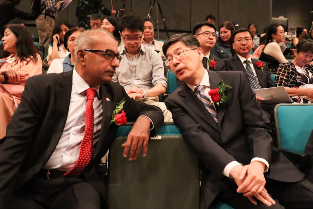 Nepean MP Chandra Arya (left) talks with China's ambassador to Canada, Cong Peiwu, on Oct. 1 at the Algonquin Commons Theatre.