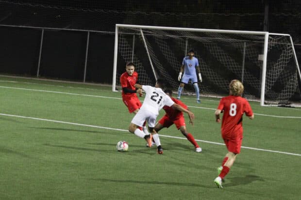 Mecheri Mohammed Houssad dribbling past Senecas players.