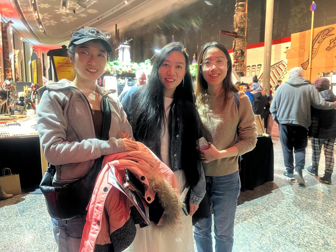 Yu Song, Yuling Guo and Vivianne Pan, Computer programming students, enjoy browsing the Christmas market after taking in the exhibits at the Canadian Museum of History on Nov. 23.