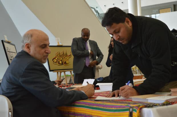 Sarfraz Khan, a professor for Informations and Communications Technology at Algonquin College, wrote down his and his wife's names to get written in Arabic.