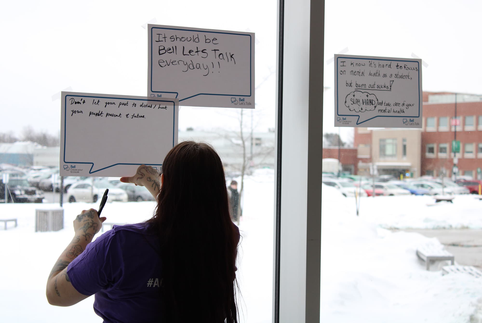 A staff member at the Students' Association displays some of the messages written by students at the event.