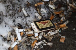 A large number of cigarette butts were scattered in the corner of the ACCE building near the Baseline entrance.