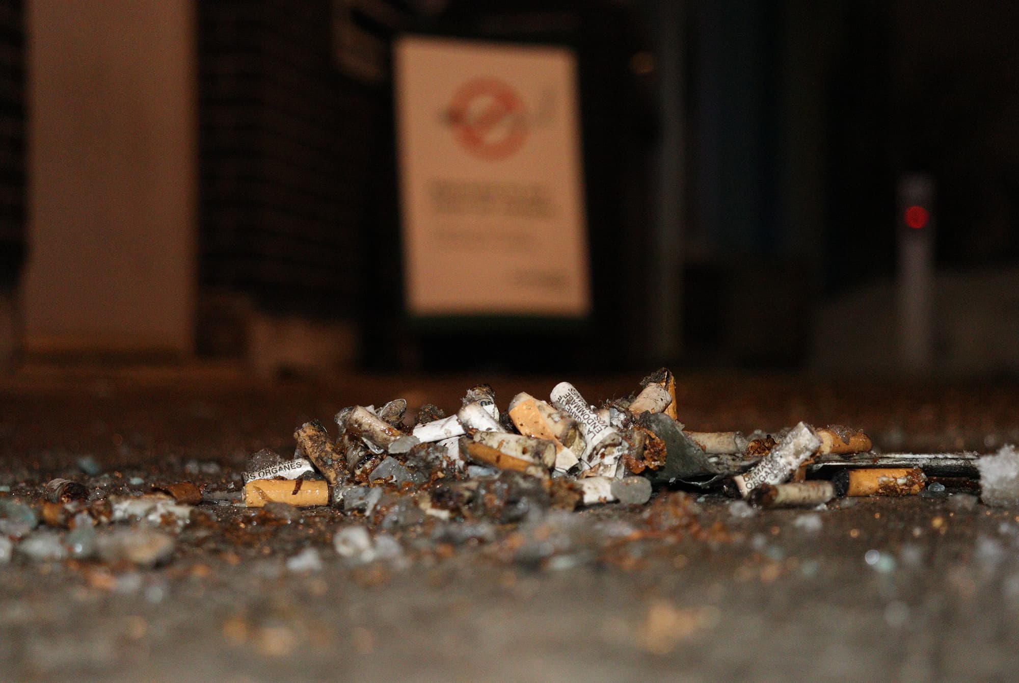 A small pile of cigarette butts was scattered in front of a 