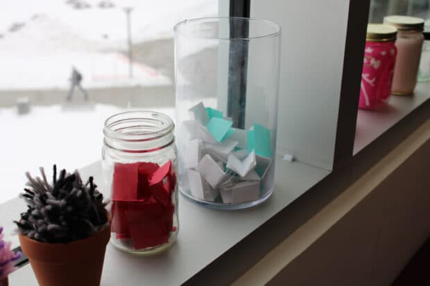 The two jars full of folded-up pieces of paper that was used for the Snack and Chat event.