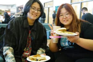 Jieyu Chen (left) and Xueting Wang (right) are early childhood education students who arrived early at the student commons to wait for the Lunar New Year's event to begin.